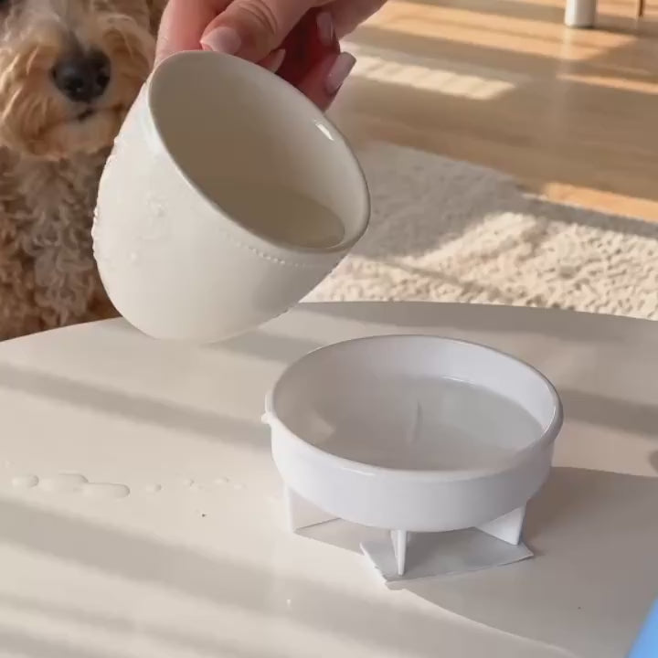 Dog using the blue calming lick bowl with rolling white ball