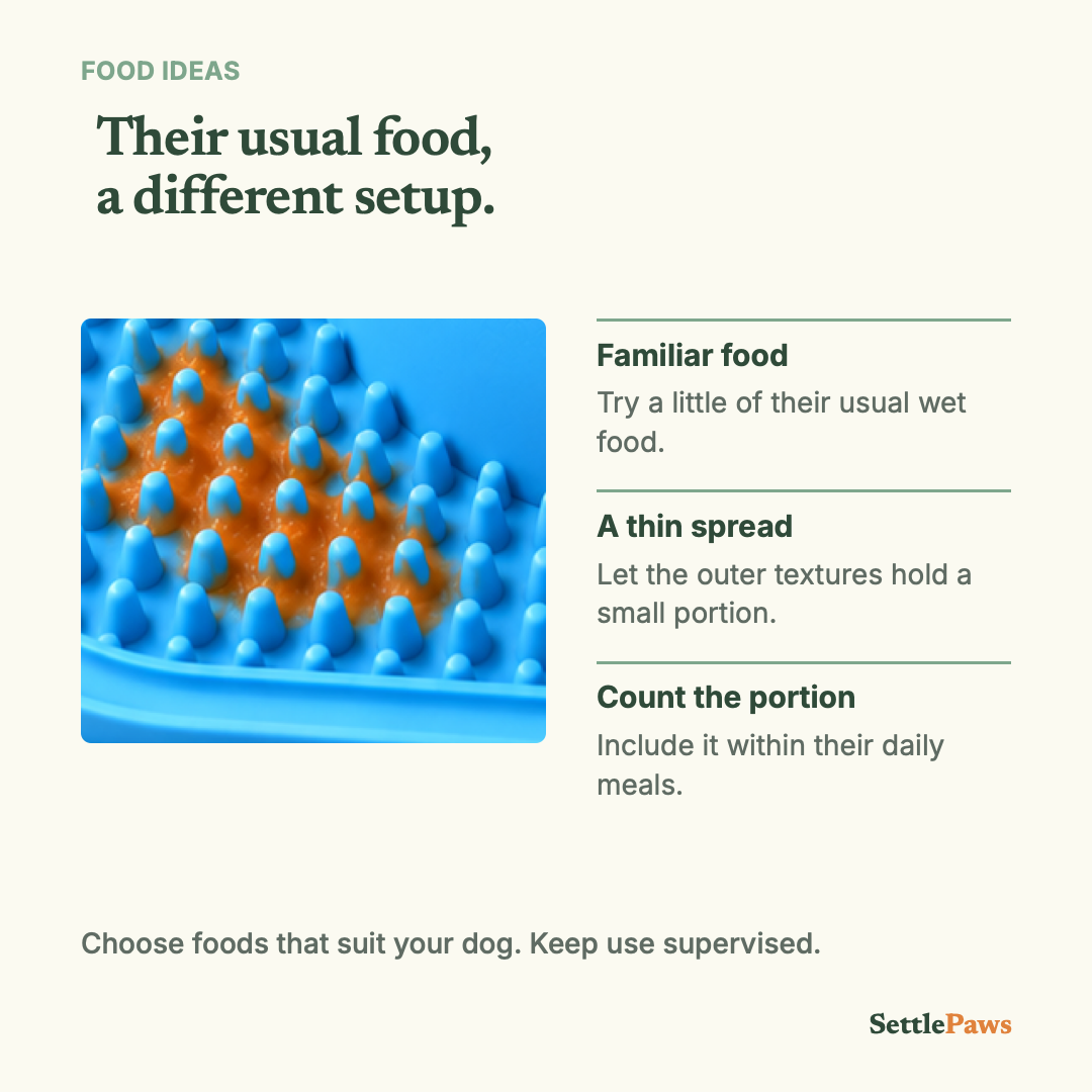 Small soft-food spread between the blue white-ball mat's raised studs, with portion and supervision guidance.