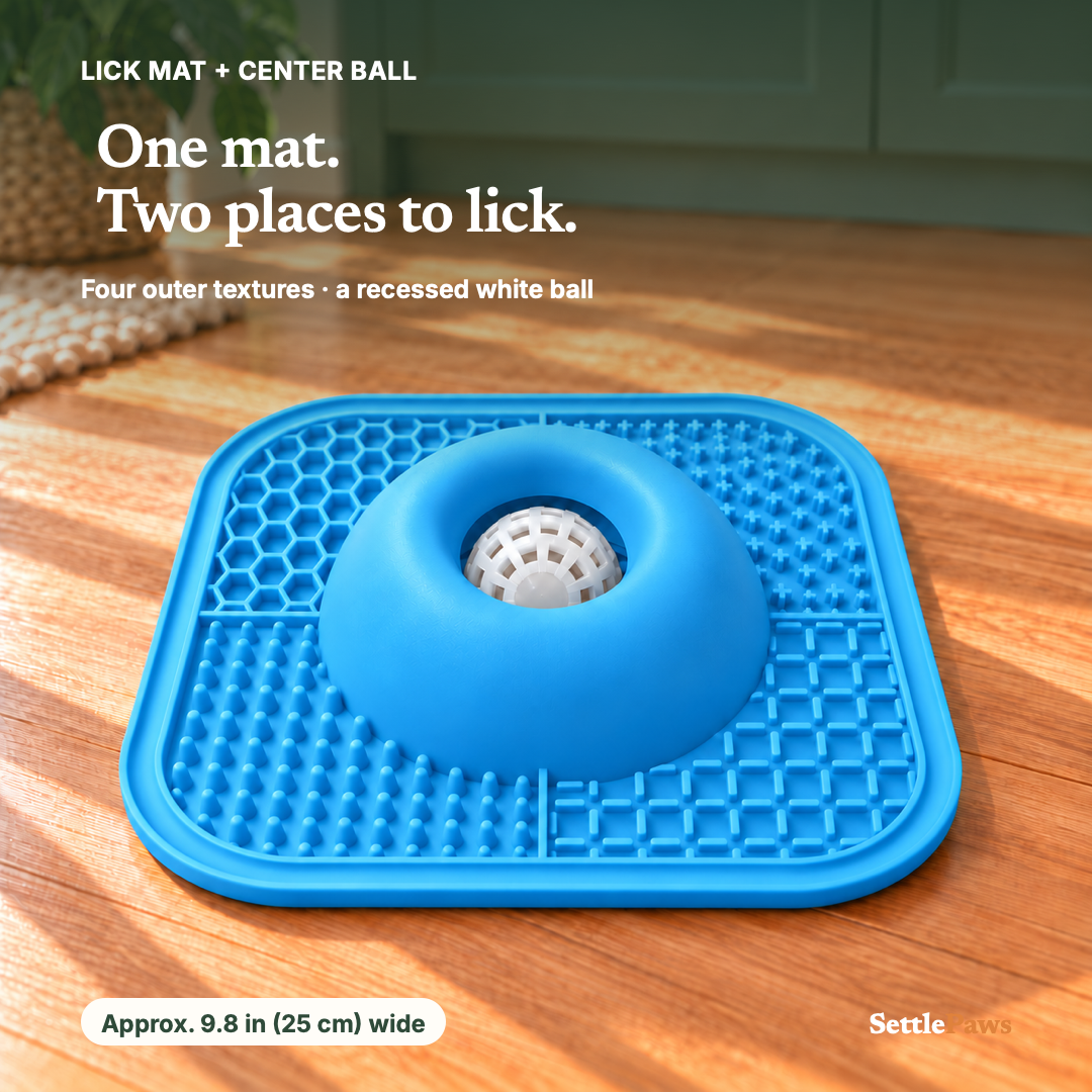 Blue lick mat with four outer textures and a recessed white ball on an oak floor.