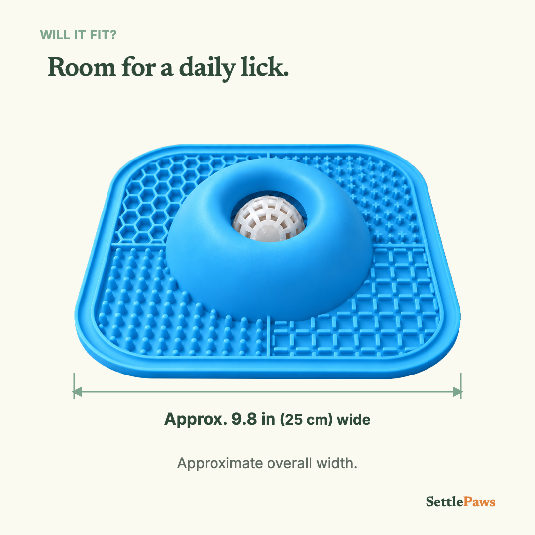 Blue lick mat with a recessed white ball, showing approximate overall width of 9.8 inches (25 cm).
