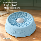 SettlePaws powder-blue silicone lotus lick bowl with petal grooves and textured center ball on oak floor